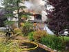 The burning home at 84 Berkley Avenue that was destroyed after a small plane flew into it.
