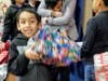 A student opens up a gift last week at Livingston Elementary in New Brunswick.