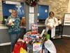 IMA Urgent Care - Shrewsbury's Office Manager, Angie and Dr. Bhoori packing up donations for delivery to Middletown Helps Its Own