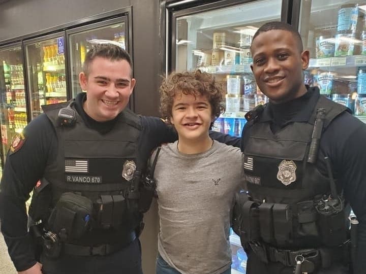 Gaten Matarazzo poses with two members of Woodbridge's finest Friday night, Feb. 7.