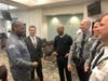 From left: Travis jokes around with Monmouth County Prosecutor Chris Gramiccioni, his father, Tyrone White, and members of the Holmdel police department.