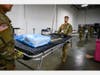 Army soldiers set up the hospital beds.