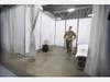 The beds look similar to Army cots and each has a white curtain for privacy.