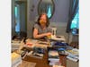Abby Daly of Bridge of Books sorts books to be delivered to IMA’s senior citizen patients.