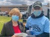 Edison Republican Chair Sylvia Engel makes a contribution to the “Hands of Hope,” standing with food pantry board member and Middlesex County Freeholder Charles Tomaro.
