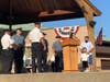 The boy's mother thanks the police officers, as her husband and son look on.