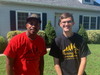 Evan, right, with Rodney Smith, Jr., the founder of Raising Men Lawn Care Service. The group organizes young people, ages 7 to 17, to do law maintenance for free for seniors, the disabled, single moms and U.S. veterans.
