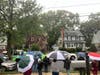 The crowd across the street from the tree where the bear was. The bear is in the large tree just to the right of the brown house.