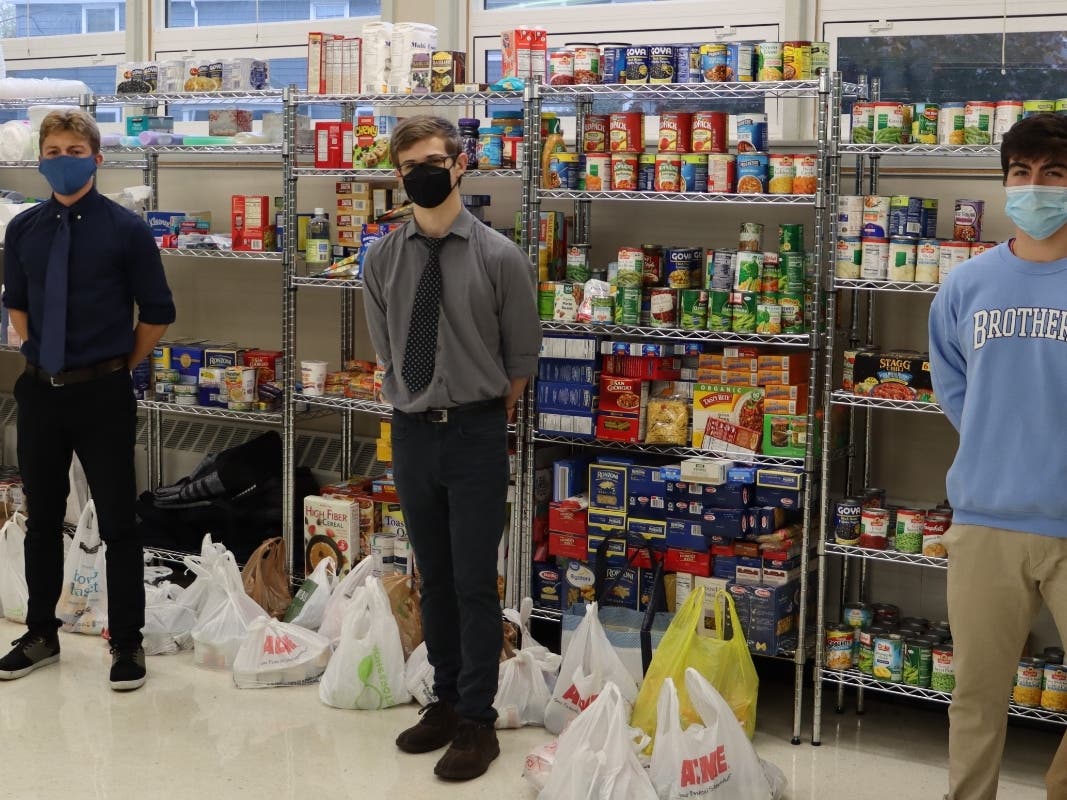 CBA students with the donated food items. It will go to seven different food pantries and shelters in Monmouth and Ocean counties.