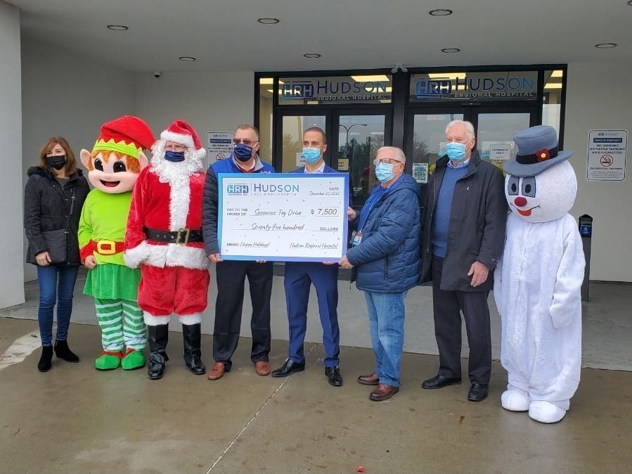 Councilwoman Orietta Tringali, an elf, Santa, Mayor Mike Gonnelli, Dr. Nizar Kifaieh, Hudson Regional Hospital Board member John Reilly, Secaucus Councilman William McKeever and Frosty the Snowman.