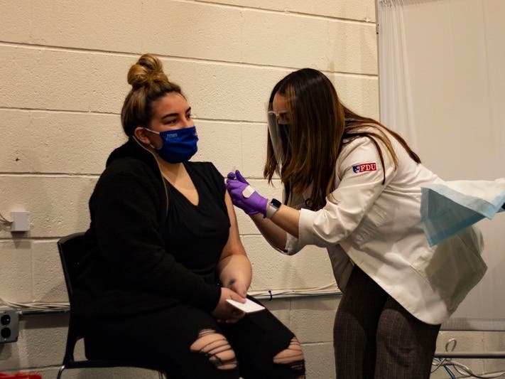 New Jersey resident Kyla Bonaguare receives her COVID vaccine shot at Holy Name Medical Center in Teaneck.