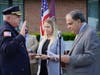 Aberdeen Police Chief Al Geyer is formally sworn in by Mayor Fred Tagliarini as his daughter looks on.