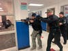 Secaucus police officers train searching for an active shooter, as they run down a hallway at the high school.