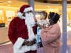 Santa Claus greets patient Bryce Somers and his mom Yvette Barnett-Somers on his visit Saturday.