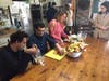 Oasis residents peel apples in the kitchen for applesauce and apple pie, while a counselor helps out.