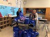 Ocean Avenue School principal Cynthia Wilson and staff member sorting IMA Back-To School supply donations in 2021.