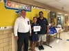 Bayview Elementary School principal Tara Raspanti, center, with the donated school supplies.