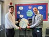 The Indian-American civic group gave 16 backpacks to Indiana Avenue School #18, received by school principal Chris Chiera.