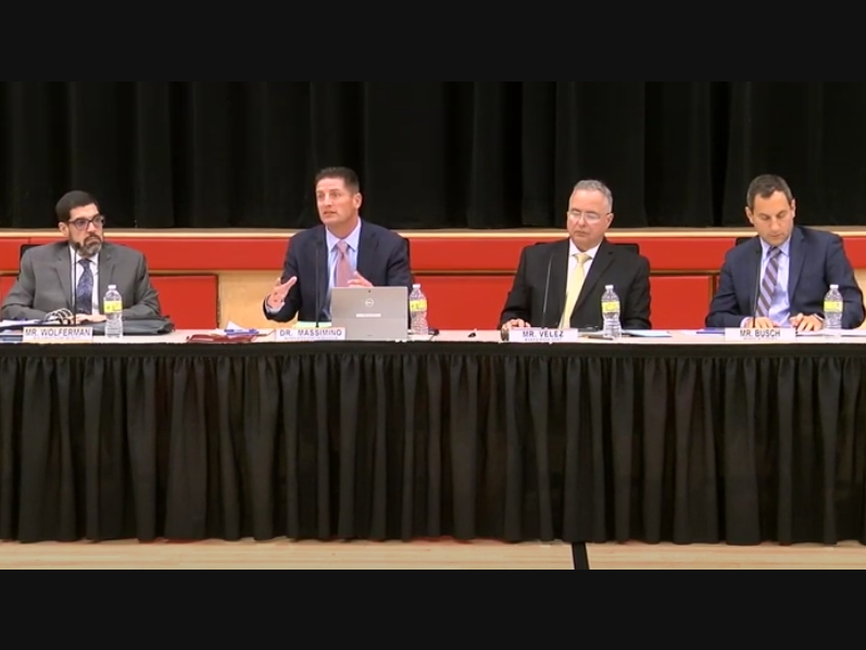 Dr. Joseph Massimino, second from left, speaks at last Thursday's Woodbridge school board meeting.