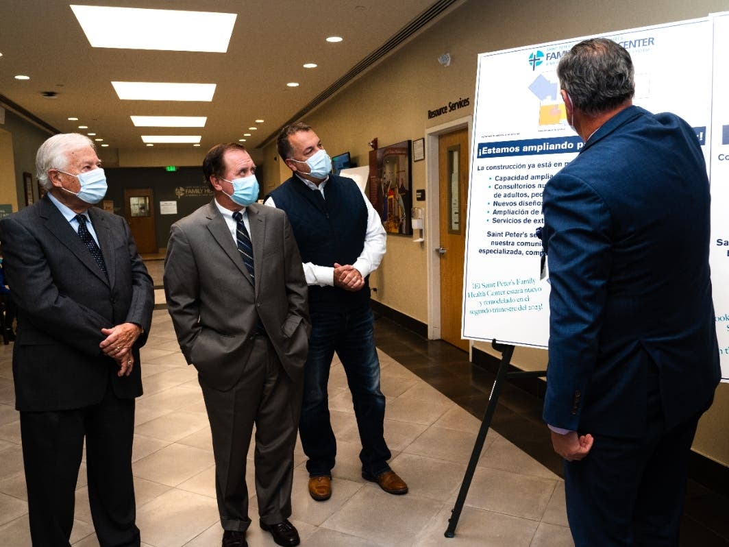 New Jersey Assembly Speaker Craig J. Coughlin, center, is given a preview of how the upgraded Saint Peter’s Family Health Center will look.