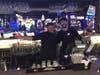 Employees smile behind the bar at the Woodbridge Dave & Buster's.