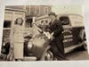 Elsie Kelly with her parents; she is the little girl next to her father, Edward Kelly, and his bakery delivery car. The family is dressed in their Sunday best.