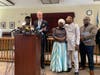 Eunice's family: Her father, Prince, at far left, and mother Mary Dwumfour, held by Eunice's husband, Peter Ezechukwu, and the family pastor Karl Badu, far right. Former Middlesex County Assemblyman John Wisniewski speaks.
