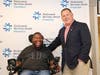 Woodbridge resident Eric LeGrand, center, with Rutgers head football coach Greg Schiano at the new spinal rehab center Wednesday.