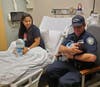 Port Authority Police Officer Timothy Jozefczyk holds the newborn Wednesday, as mom Maria Marin looks on.