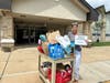Meadowbrook Elementary School in Eatontown’s school secretary Carol Venezia helping load donations.