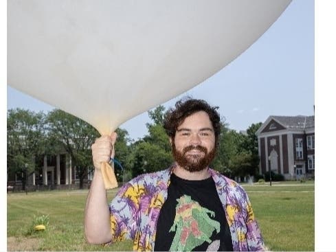 Sam Ehret, who is getting his college degree in physics, with a weather balloon.
