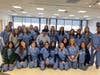 All participating students, teachers and Hudson Regional Hospital staff pose in their scrubs.