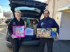 IMA Urgent Care of Middletown’s physician assistant Alex and Dr. Soliman help load up donated toys.