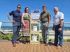 Long Branch resident Stacy Walker, center, with Mayor John Pallone, at right, of the new beach clean-up station.