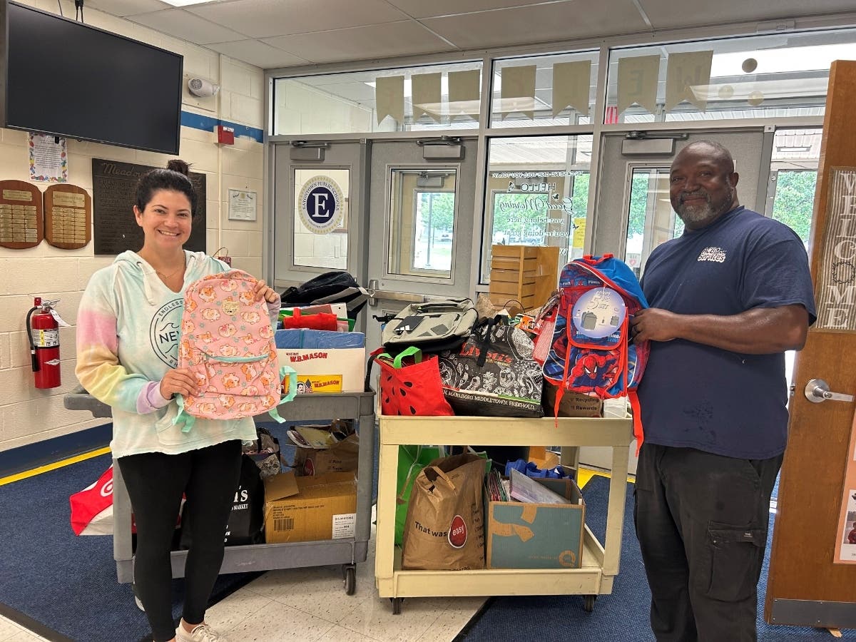 Employees at Meadowbrook School with donations last August.