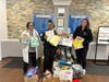 Dr. Nafisa Boohri at IMA Urgent Care Shrewsbury and staff with donations last year.