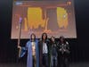 The four of them dressed as wizards promoting the game.