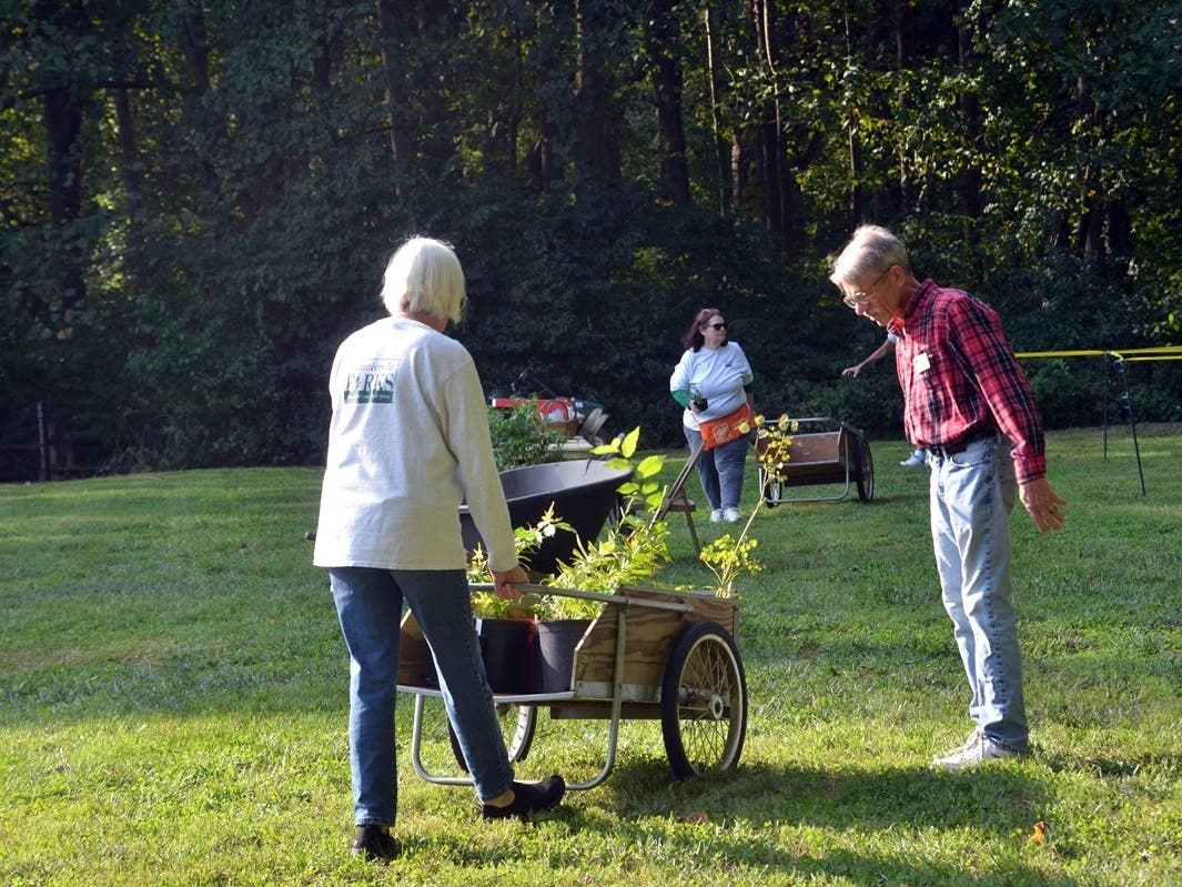 People exchanging plants at the Native Plant Exchange in previous years.