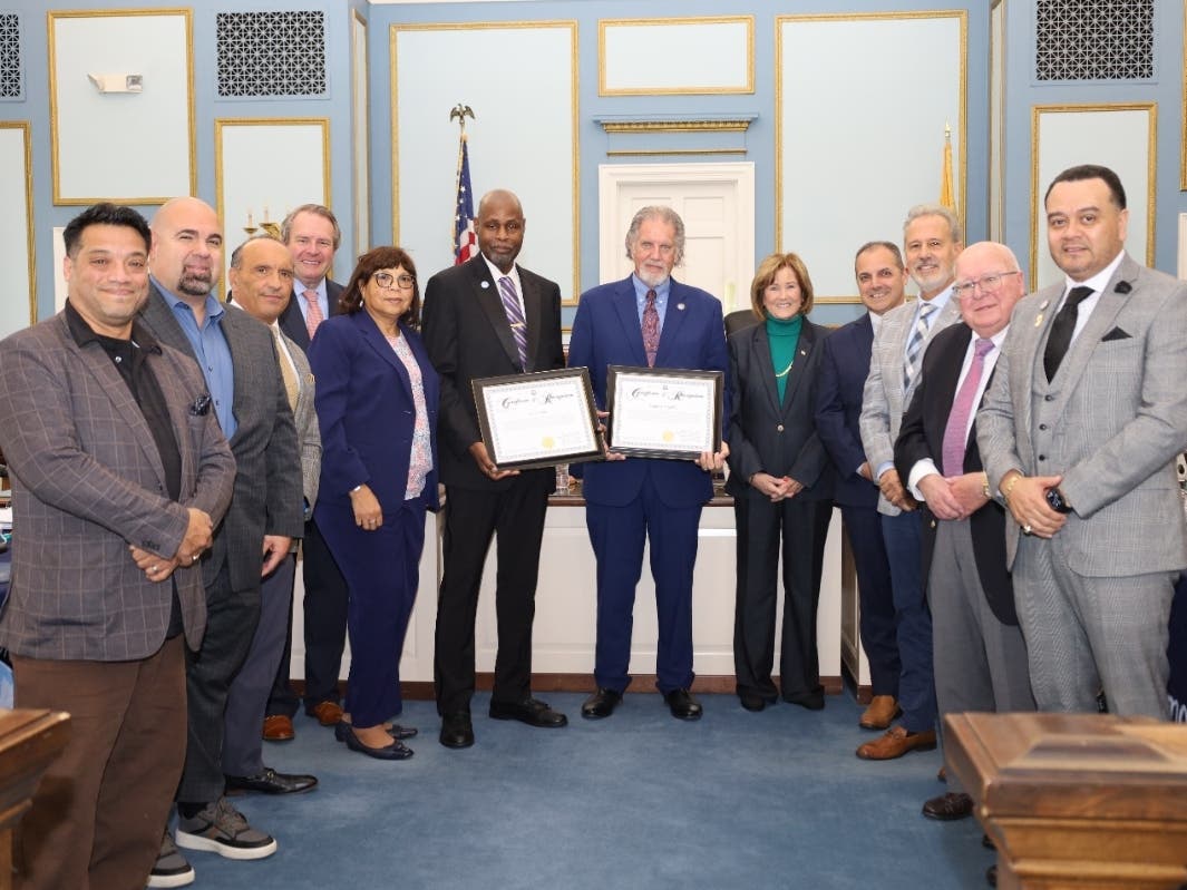 Louis Jordan, holding the plaque on the left, was recognized at the Sept. 24 meeting.