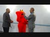 Elmo greets PSE&G employees last Thursday at the Acacia Center.