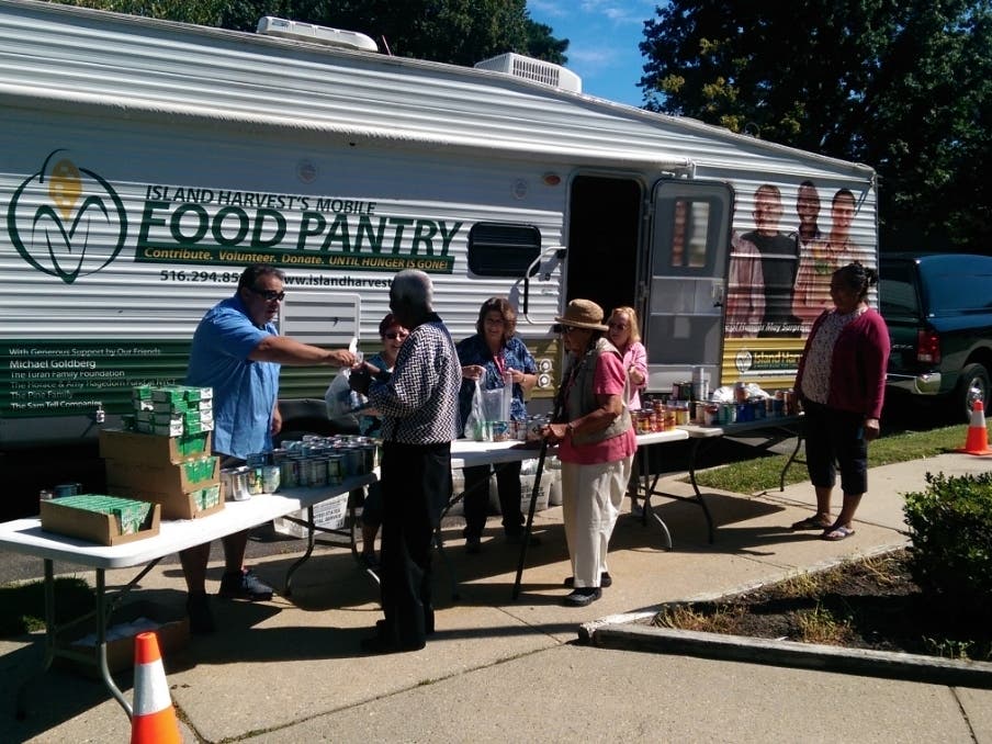 Island Harvest's mobile food pantry brings supplemental food support and social services to people in need
