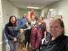 Susan Sherman, co-founder of General Needs, with volunteers Glenn Fitze, Cindy Habberstad, Marsh Knopp, Lonnie Sherman, co-founder of General Needs, Margaret Benders, and Trina Zendrian, seen with boots and coats donated to veterans at the Northport VA