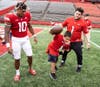 Rutgers Sophomore Running Back Isaih Pacheco helps Tommy Marcketta (middle) with their touchdown “spike” celebration.​