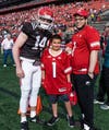 Rutgers Freshman Quarterback Cole Snyder poses for a photo with Tommy Marcketta (middle) and Lamont Banks (right).