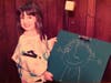 Michele Sobel as a child with one of her first art pieces.