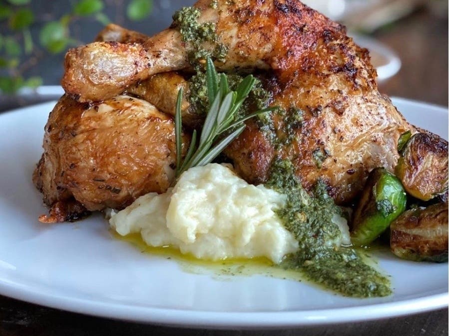 Rotisserie Chicken with creamy yukon mashed potatoes, brussels sprouts, and salsa verde.
