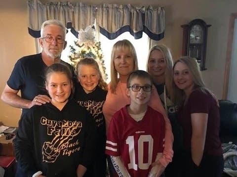 The rescued driver of the tractor trailer, Ron Hickman, with his family.