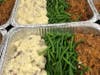 Pulled pork with mashed potatoes and green beans.