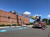 Clark firefighters rescued a person stuck on top of the roof of a township business on Tuesday.