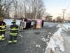 A driver was rescued by Clark firefighters after the dump truck overturned on icy roads in the township.